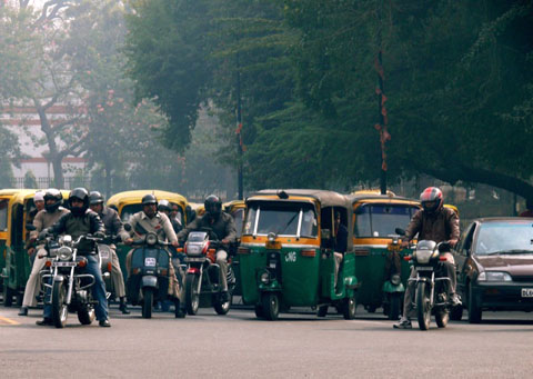 Auto-rickshaws at a traffic intersection in New Delhi