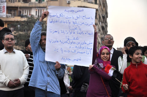 Egyptians holding a poem celebrating the new era of Egyptian history; photo by Joseph Hill